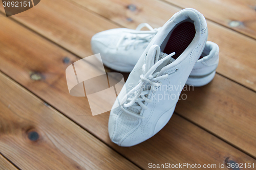 Image of close up of sneakers on wooden floor