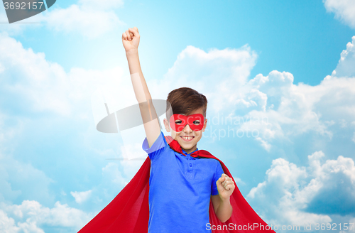 Image of boy in red superhero cape and mask showing fists