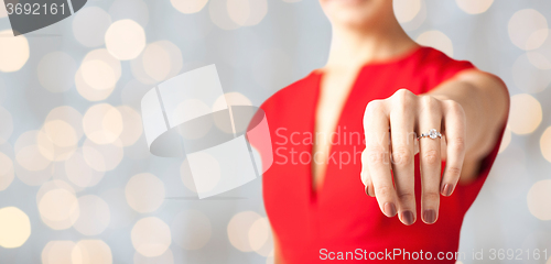 Image of close up of woman showing wedding ring on her hand