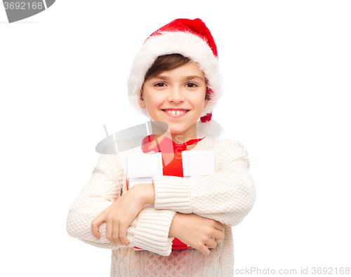 Image of smiling happy boy in santa hat with gift box