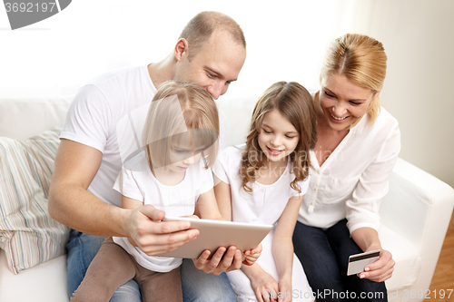 Image of happy family with tablet pc and credit card
