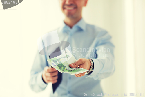 Image of close up of businessman hands holding money