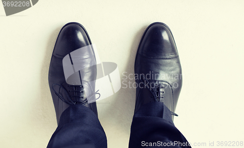 Image of close up of man legs in elegant shoes with laces