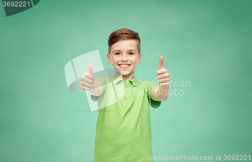 Image of happy school boy in t-shirt showing thumbs up