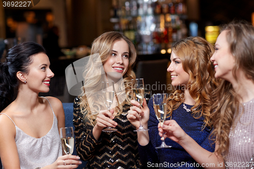 Image of happy women with champagne glasses at night club