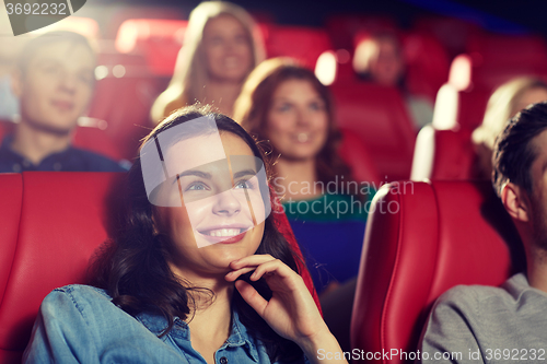 Image of happy friends watching movie in theater