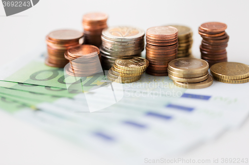 Image of close up of euro paper money and coins on table