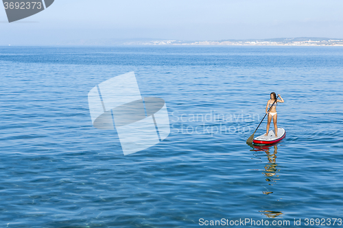 Image of Woman practicing paddle