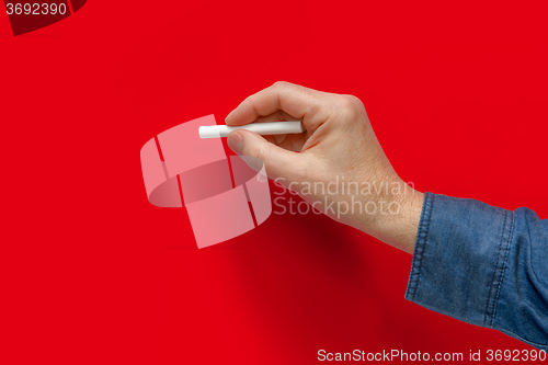 Image of hand with white crayon