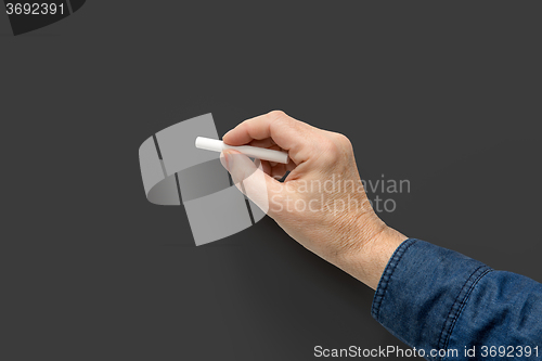 Image of hand with white crayon