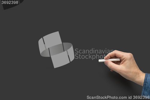 Image of hand with white crayon