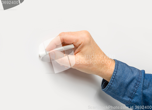 Image of hand with white crayon