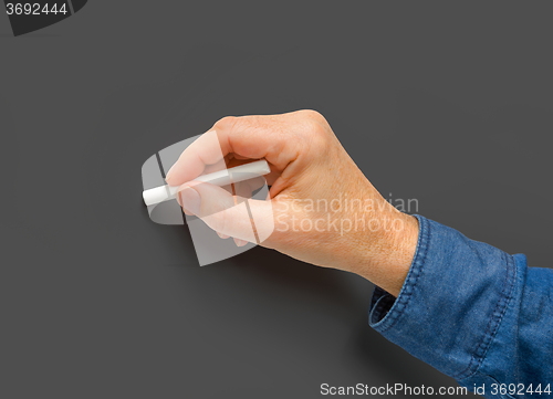 Image of hand with white crayon