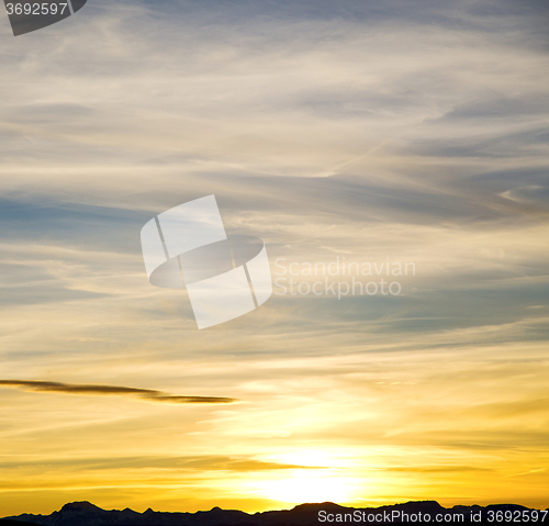 Image of sunrise in the colored sky white soft clouds and abstract backgr