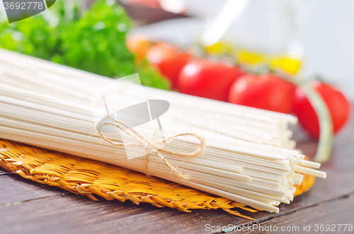 Image of raw pasta and  tomato and sauce