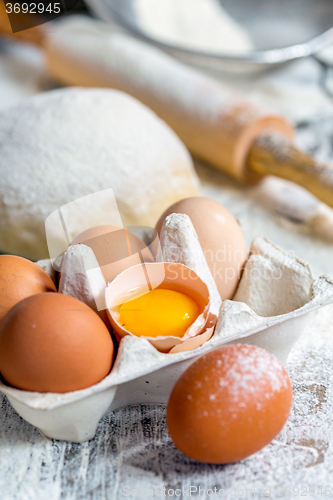 Image of Tray with eggs, dough and rolling pin.