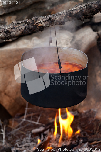 Image of Pot with soup cooking on campfire