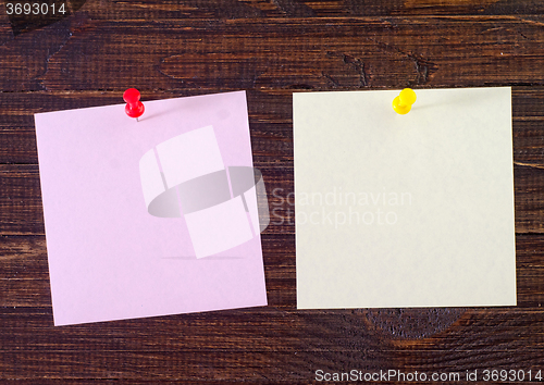 Image of color paper on wooden background