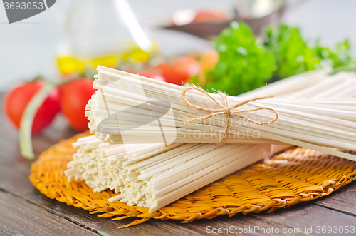 Image of raw pasta and  tomato and sauce