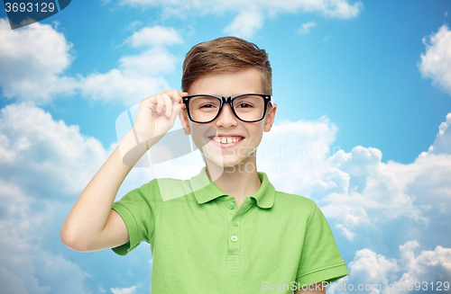 Image of happy boy in green polo t-shirt and eyeglasses