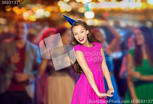 Image of happy young woman or teen girl in party cap