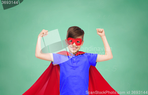 Image of boy in red super hero cape and mask showing fists