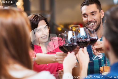 Image of friends clinking glasses of wine at restaurant