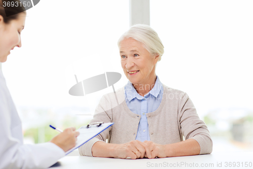 Image of doctor with clipboard and senior woman at hospital