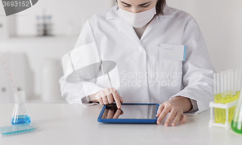 Image of close up of scientist with tablet pc in laboratory