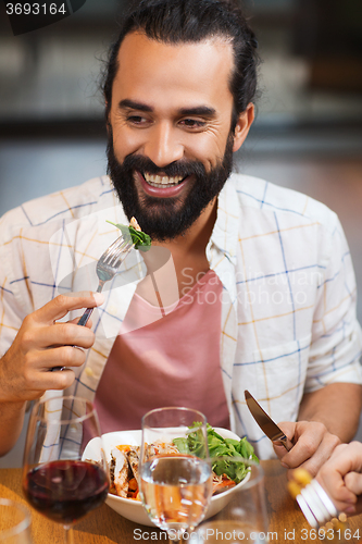 Image of happy man having dinner at restaurant