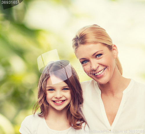 Image of smiling mother and little girl