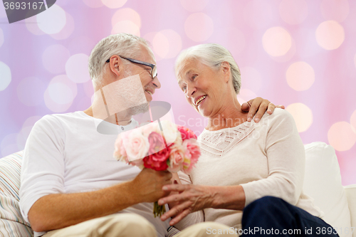 Image of happy senior couple with bunch of flowers