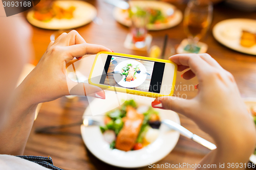 Image of hands photographing food by smartphone 