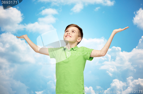 Image of happy boy in polo t-shirt raising hands up