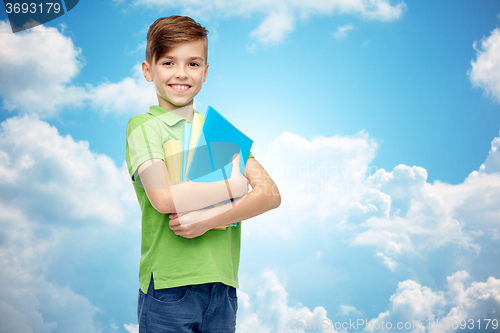 Image of happy student boy with folders and notebooks