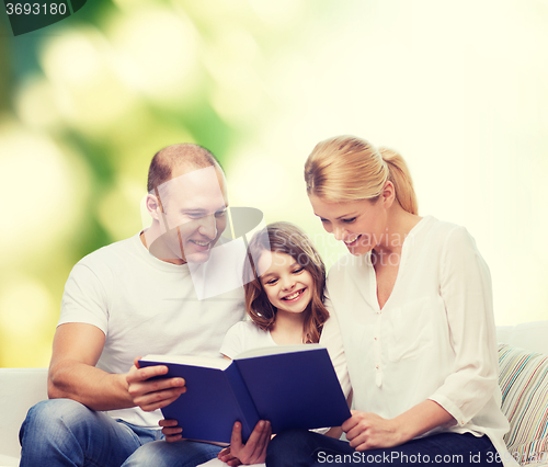 Image of happy family with book at home