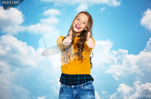 Image of happy young woman or teen girl showing thumbs up