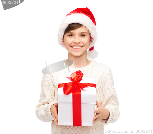 Image of smiling happy boy in santa hat with gift box