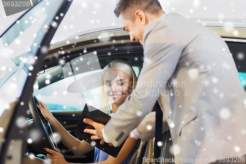 Image of happy woman with car dealer in auto show or salon