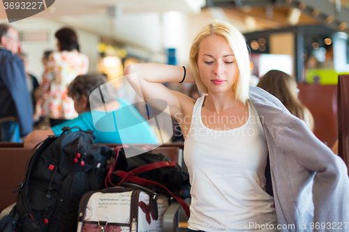 Image of Female traveler putting on her jacket.