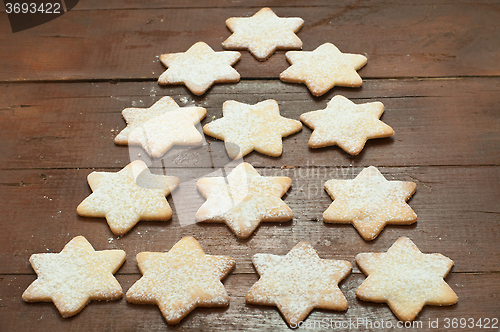 Image of Christmas cookies in the shape of star with flour and butter