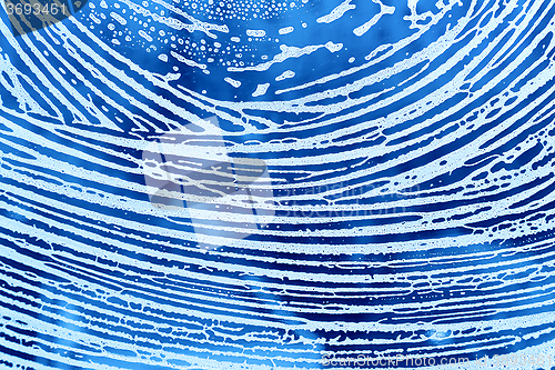 Image of Abstract lines of natural soap foam on the glass
