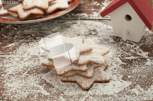 Image of Christmas cookies in the shape of star with flour and butter