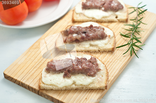 Image of Crispy bruschetta topped with sausage and fresh rosemary