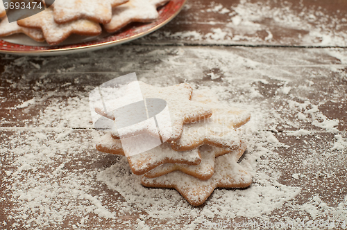 Image of Christmas cookies in the shape of star with flour and butter