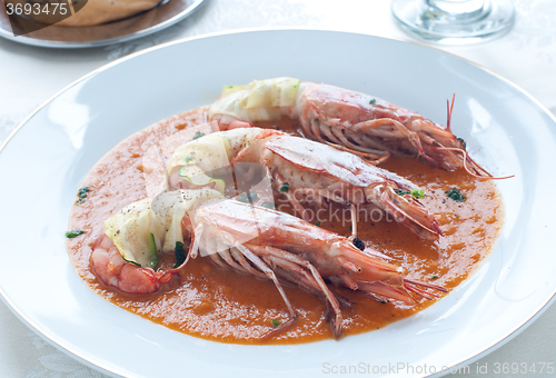 Image of Prawns wrapped in zucchini with bisque sauce