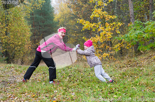 Image of Woman with girl doing aerobics in the park