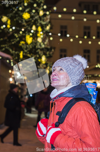 Image of Woman looks at decorated Christmas Town Hall Square in Tallinn