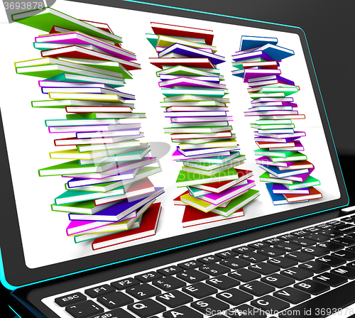 Image of Pile Of Books On Laptop Showing Studying