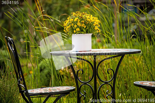 Image of Garden with desk and bouquet of flowers